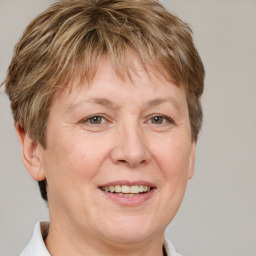 Joyful white adult female with short  brown hair and grey eyes