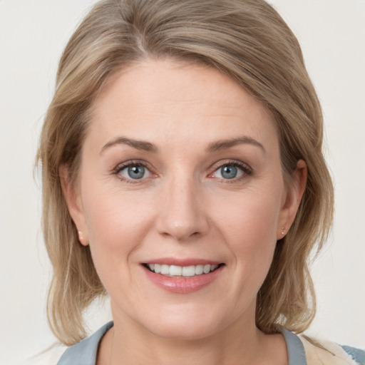 Joyful white young-adult female with medium  brown hair and blue eyes