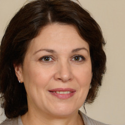 Joyful white adult female with medium  brown hair and brown eyes