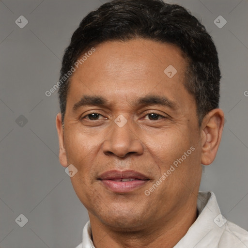 Joyful latino adult male with short  brown hair and brown eyes