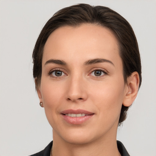 Joyful white young-adult female with medium  brown hair and brown eyes