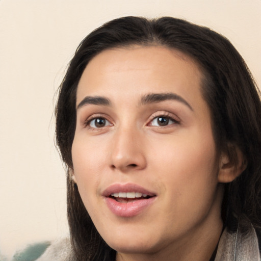 Joyful white young-adult female with long  black hair and brown eyes