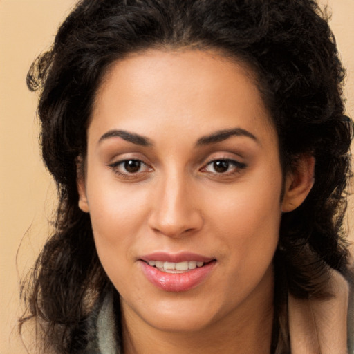 Joyful latino young-adult female with long  brown hair and brown eyes