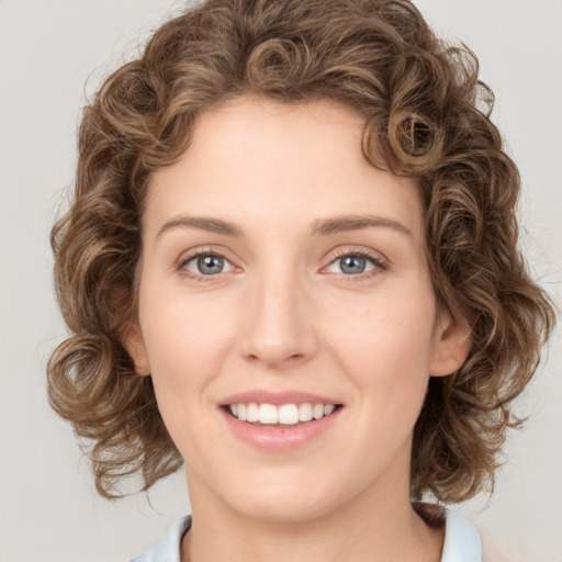 Joyful white young-adult female with medium  brown hair and green eyes