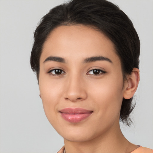 Joyful latino young-adult female with medium  black hair and brown eyes