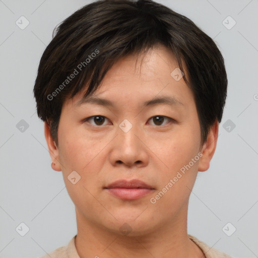 Joyful asian young-adult male with short  brown hair and brown eyes