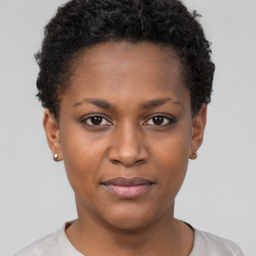 Joyful black young-adult female with short  brown hair and brown eyes
