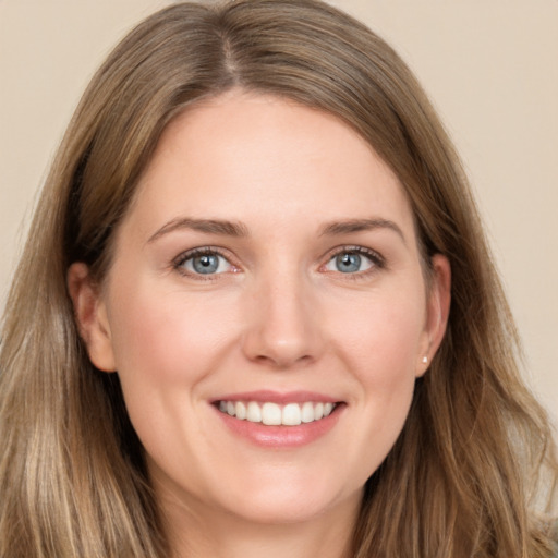 Joyful white young-adult female with long  brown hair and grey eyes