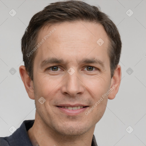 Joyful white adult male with short  brown hair and grey eyes