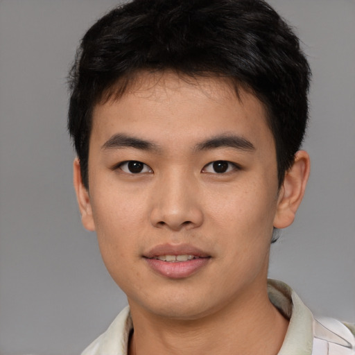 Joyful asian young-adult male with short  brown hair and brown eyes