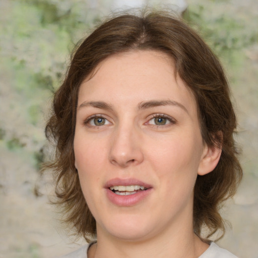 Joyful white young-adult female with medium  brown hair and green eyes