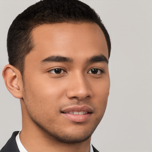 Joyful latino young-adult male with short  brown hair and brown eyes