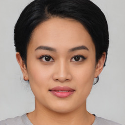 Joyful asian young-adult female with medium  black hair and brown eyes