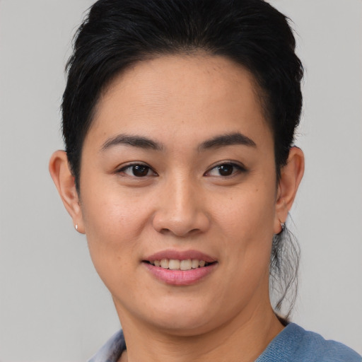 Joyful asian young-adult female with short  brown hair and brown eyes