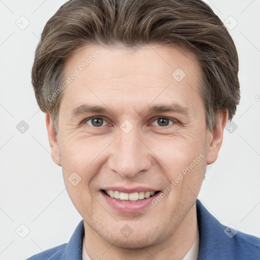 Joyful white adult male with short  brown hair and grey eyes