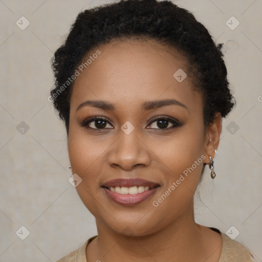 Joyful black young-adult female with short  brown hair and brown eyes