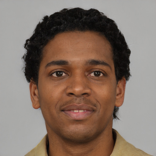 Joyful black young-adult male with short  black hair and brown eyes