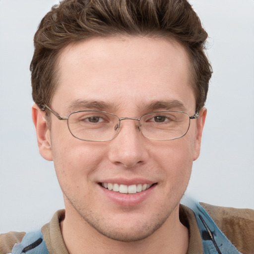 Joyful white adult male with short  brown hair and blue eyes