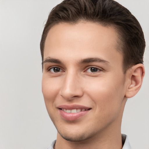 Joyful white young-adult male with short  brown hair and brown eyes