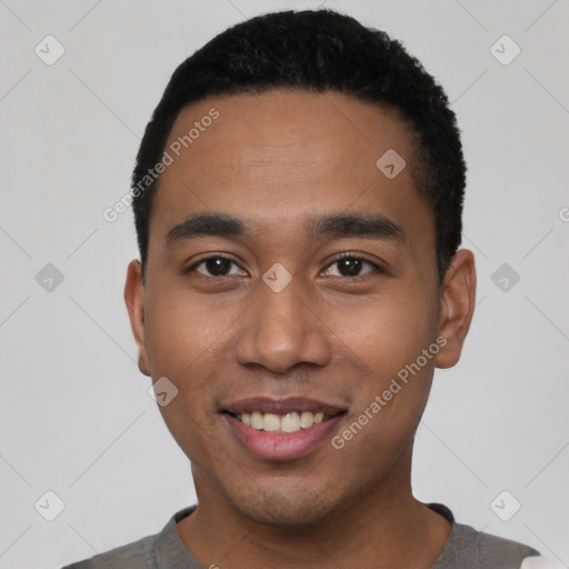 Joyful latino young-adult male with short  black hair and brown eyes