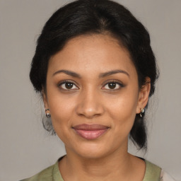 Joyful black young-adult female with medium  brown hair and brown eyes