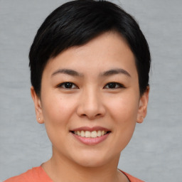 Joyful asian young-adult female with short  black hair and brown eyes