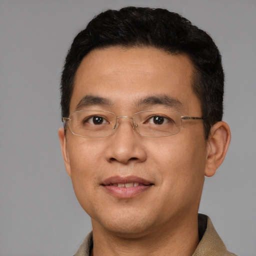 Joyful white adult male with short  black hair and brown eyes
