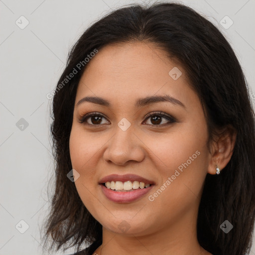 Joyful latino young-adult female with long  brown hair and brown eyes