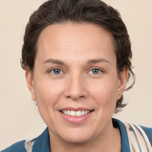 Joyful white adult female with short  brown hair and grey eyes