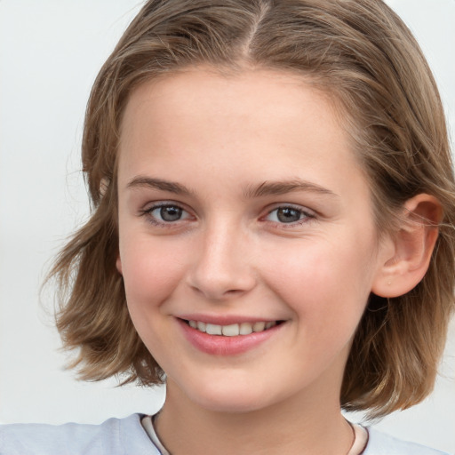 Joyful white child female with medium  brown hair and grey eyes