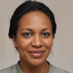 Joyful black adult female with medium  brown hair and brown eyes