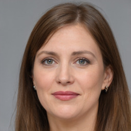 Joyful white adult female with long  brown hair and grey eyes