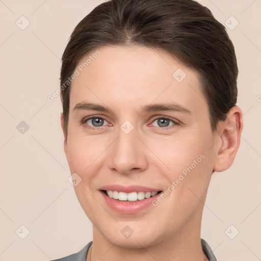 Joyful white young-adult female with short  brown hair and brown eyes