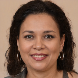 Joyful white adult female with long  brown hair and brown eyes