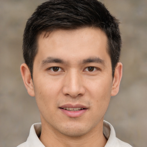 Joyful asian young-adult male with short  brown hair and brown eyes