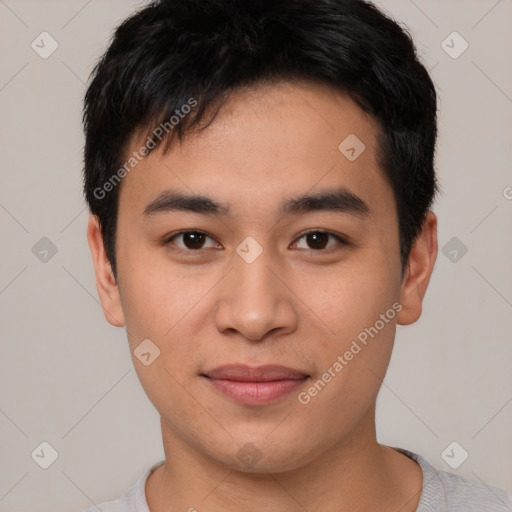 Joyful asian young-adult male with short  black hair and brown eyes