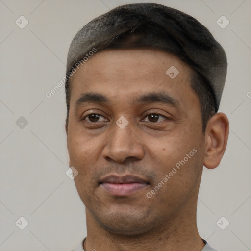 Joyful black young-adult male with short  black hair and brown eyes