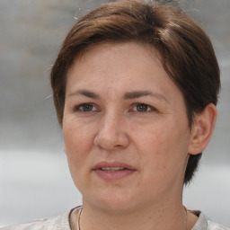 Joyful white adult female with short  brown hair and brown eyes