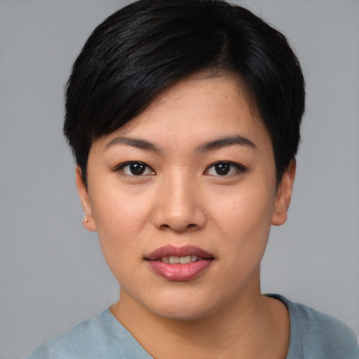 Joyful asian young-adult female with short  black hair and brown eyes