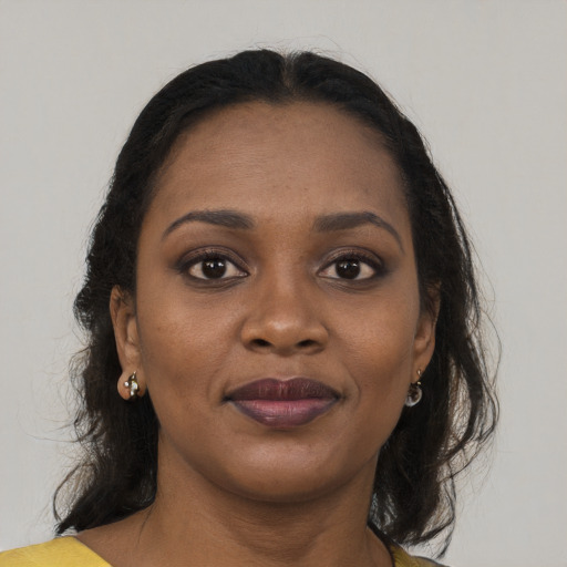 Joyful black young-adult female with medium  brown hair and brown eyes