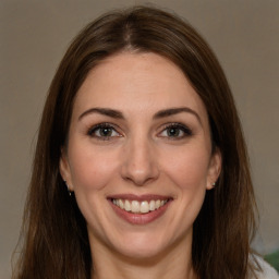 Joyful white young-adult female with long  brown hair and brown eyes