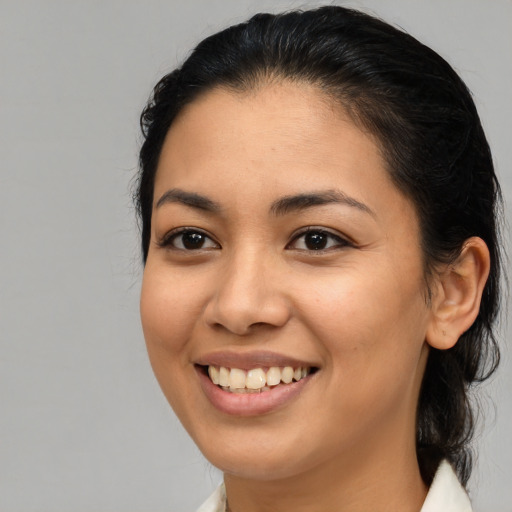 Joyful asian young-adult female with medium  brown hair and brown eyes
