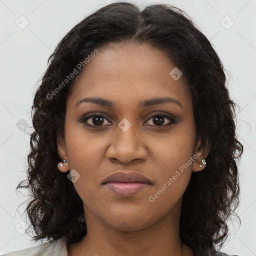 Joyful black young-adult female with long  brown hair and brown eyes