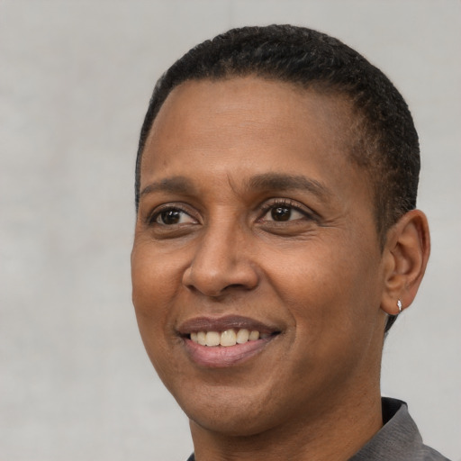 Joyful latino adult male with short  brown hair and brown eyes