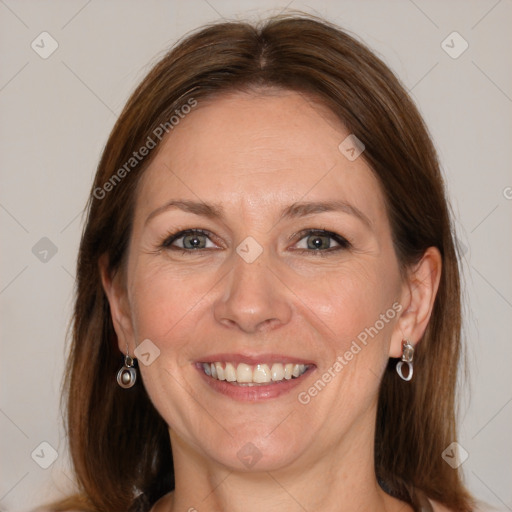 Joyful white adult female with medium  brown hair and blue eyes