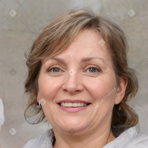 Joyful white adult female with medium  brown hair and blue eyes