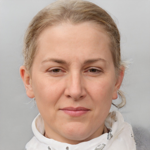 Joyful white adult female with medium  brown hair and blue eyes