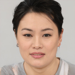 Joyful asian young-adult female with short  brown hair and brown eyes