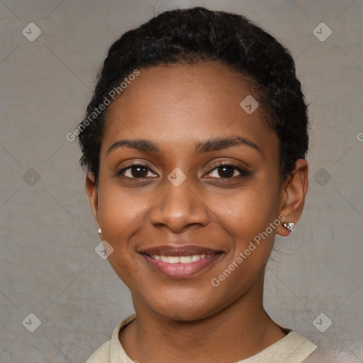 Joyful black young-adult female with short  black hair and brown eyes