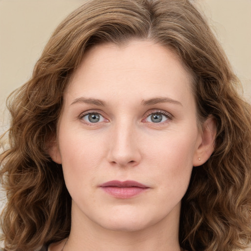 Joyful white young-adult female with long  brown hair and green eyes